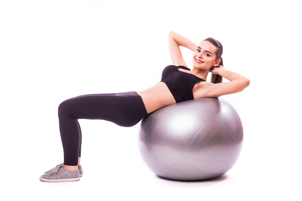 beautiful young fitness woman with gym ball exercising isolated white background 1 Can You Pay for a Planet Fitness Membership with Cash?
